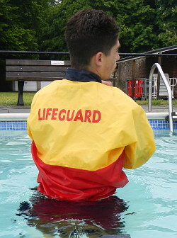 pool lifeguard swimming in uniform clothes